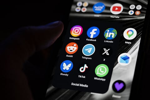 This photograph shows a set up smart-phone screen displaying the logo of main social media platforms including Instagram, Facebook, LinkedIn, Reddit, Telegram, X, Bluesky, Tiktok and Whatsapp in Saint-Mande, east of Paris, on April 29, 2026.