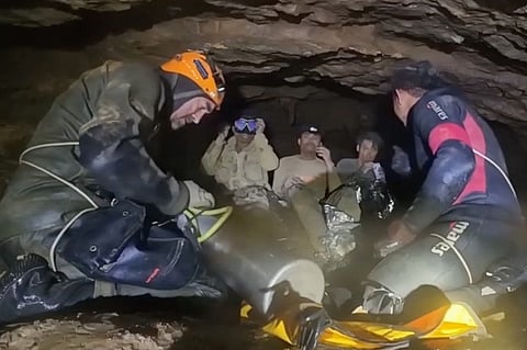 This screengrab made from handout video footage taken on May 29, 2026, and provided by Benz Norrased Palasing of Seascout Diving, shows a rescue team (foreground) training people (background) trapped in a semi-submerged cave how to use diving equipment before the first of them was freed, in central Xaysomboun province, northeast of the capital Vientiane. A rescue team freed on May 29, one of seven men trapped inside a semi-submerged cave in Laos for more than a week, the group working at the site said.