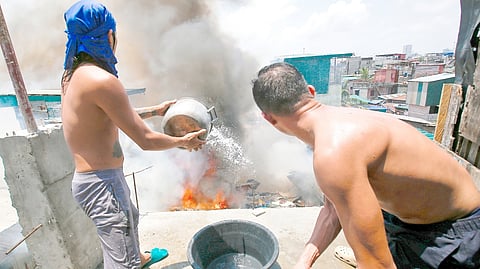FIREFIGHTERS and residents join forces to contain a third-alarm fire at the Baseco Compound in Manila’s Port Area on Saturday, just days after another blaze struck a nearby riverside community.