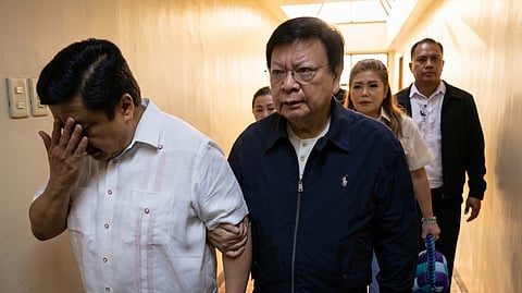 SENATOR  Jinggoy Estrada is overcome with emotion as colleagues Dante Marcoleta and Imee Marcos accompany him out of the Senate building to meet an arresting party serving a Sandiganbayan warrant for plunder.