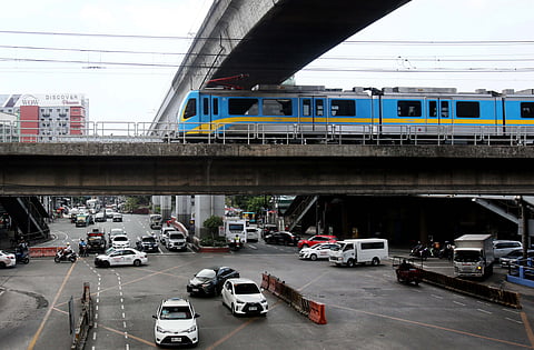 LIKE a steel serpent threading through the city, an MRT-3 train glides along the tracks in Quezon City. In celebration of Independence Day on 12 June, the Department of Transportation is offering free rides to all MRT-3 passengers.