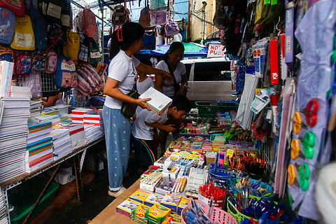 PARENTS and their children crowd a marketplace in a tiangge in Baclaran, Pasay City, on Saturday to buy affordable school supplies, two days before the official start of the school year. Baclaran is a go-to destination for budget-conscious shoppers.