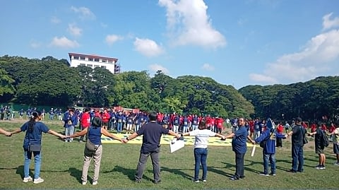 Oceana Philippines organized a human banner consisting of fisherfolks (wearing blue t shirts) and youth participants (wearing red camisa de chinos) as part of the Kwentong Dagat: Kinse kilometro para sa mangingisda advocacy.