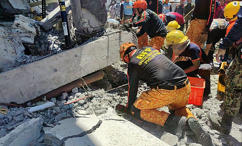 BUREAU of Fire Protection personnel continue to dig through the rubble of a building that collapsed after the magnitude 7.8 earthquake struck Mindanao on Monday, as search and retrieval operations remain ongoing amid fears that survivors may still be trapped beneath the debris.