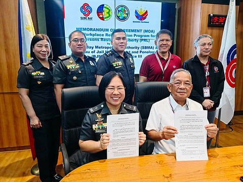 SBMA Chairman and Administrator Eduardo Jose L. Aliño (seated, right) and Bureau of Jail Management and Penology (BJMP) Regional Director JCSupt Ma. Annie A. Espinosa (seated, left) show the signed Memorandum of Agreement (MOA) for the Workplace Reintegration Program intended for Persons Restored of Liberties (PRLs) held at the SBMA Boardroom on Thursday, June 4. 