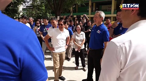 President Ferdinand Marcos Jr. and SM Prime Holdings chair of the executive committee, Hans Sy having a light moment during the unveiling of the Henry Sy Hall and Dao school buildings at the San Francisco High School in Quezon City on Wednesday. 