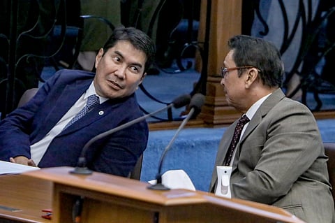 A PENNY… Senators Erwin Tulfo and Lito Lapid share a light moment during a Senate plenary session.