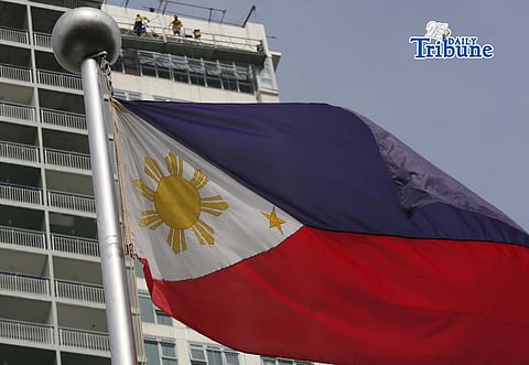 (June 11 2026) Philippine Flag waving, while the construction workers busy working at the top of the ongoing construction building in Quezon City, ahead of the observance of the Philippine Independence Day. Photo/Analy Labor
