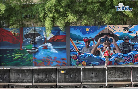 (June 12 2026) Motorists and pedestrians walk past at the colorful mural symbolizing of the rightful claim on the West Philippine Sea (WPS)  on the walls of Camp General Emilio Aguinaldo High School along Boni Serrano Avenue in Quezon City on Friday, Araw ng Kalayaan, June 12 2026. The murals are part of the WPS Mural Festival nationwide visual art competition and civilian campaign with the theme "Kulayan ang Karagatan para sa Kalayaan" (Color the Ocean for Freedom). Photo/Analy Labor