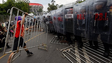 PROTESTERS clash with police as they try to push barriers near the Mexico City Stadium during demonstrations against the opening of the FIFA World Cup 2026 in Mexico City on 11 June 2026.