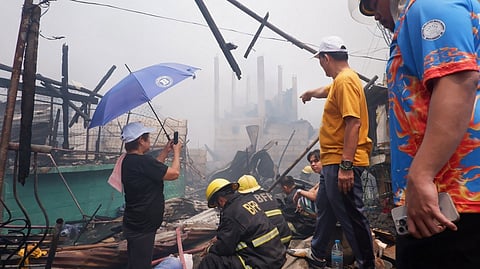 FIRE officials and local authorities assess the destruction in Ato Side and Sitio Pinaglabanan, Barangay Western Bicutan, Taguig City, following a massive fire that displaced approximately 200 families.
