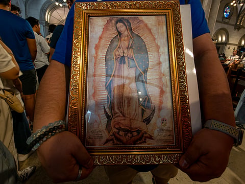 Catholic devotees line up before the images of Our Lady of Guadalupe and St. Juan Diego at the Manila Cathedral in Intramuros, Manila on 14 June 2026. The replica, sent to the Philippines from Mexico, will remain at the cathedral until 18 June before traveling to churches across Luzon, Visayas, and Mindanao until December 2026.
