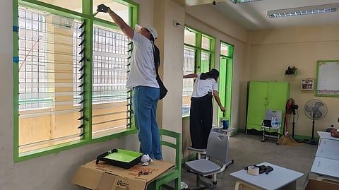 VOLUNTEERS repaint a classroom of Nagkaisang Nayon Elementary School in Quezon City. 