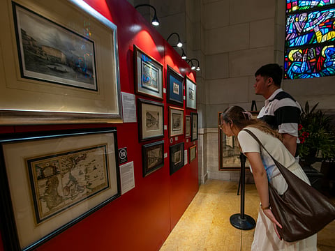 Visitors immerse themselves in history at the Manila in Prints exhibition, held at the Manila Cathedral on 14 June 2026. The display features rare antique prints, historical maps, and archival materials highlighting the rich heritage of the cathedral, the Walled City - Intramuros, and greater Manila.