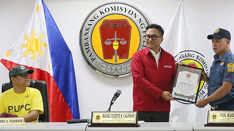 NAPOLCOMCommissioner Rafael Vicente Calinisan (middle) addresses the arrest of employee Jaime Flores (left) during a briefing in Quezon City on Monday. Flores was detained after allegedly threatening a TNVS driver with a firearm during a road rage dispute along EDSA last Friday