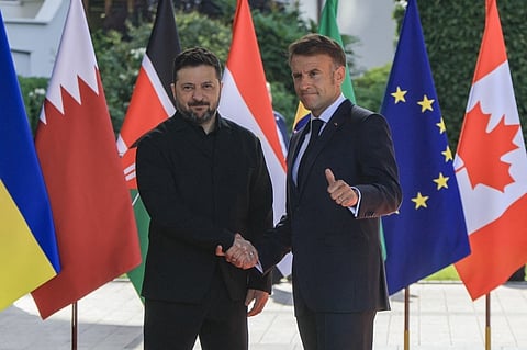 FRANCE'S President Emmanuel Macron greets Ukraine’s President Volodymyr Zelensky ahead of the working session with G7 leaders and Ukraine during the G7 summit, in Evian, eastern France.
