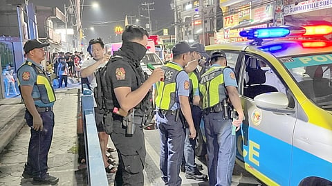 POLICE investigators process the scene along the National Road in Barangay Putatan, Muntinlupa City, where an armed disturbance suspect was shot and killed Tuesday night. The suspect was shot by backup officers in self-defense after he allegedly struck a responding policeman in the head with a stone and advanced toward him with an improvised ice pick.