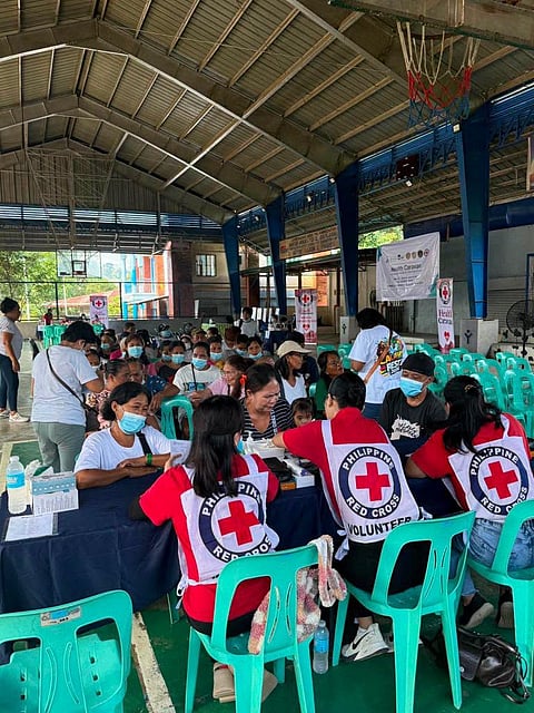 RED Cross volunteers serve patients during the health caravan in Barangay Calawis, Antipolo City.