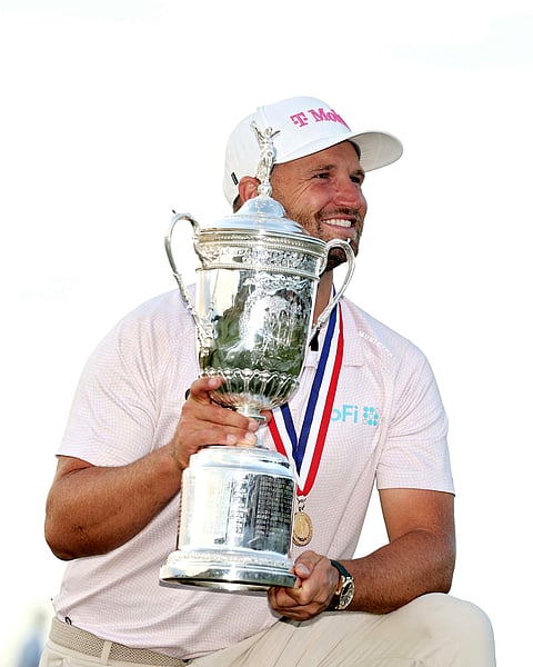 WYNDHAM Clark celebrates after completing a wire-to-wire victory in the US Open at the windy Shinnecock Hills Golf Club on Sunday. 