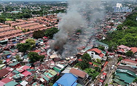 (June 23 2026) Fire-fighters and residents helping to contain the 3rd alarm fire that hit a residential area in Nia Village Brgy. Sauyo, Quezon City this Tuesday morning, June 23, 2026. Photo/Analy Labor