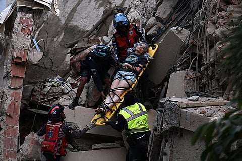 Rescue workers carry a person on a stretcher out of a collapsed building following an earthquake in Caracas on June 24, 2026. Two earthquakes of magnitude 7.2 and 7.5 struck the same area of Venezuela on the evening of June 24, causing buildings to collapse, according to the United States Geological Survey (USGS) and AFP journalists. The quakes drove residents of the capital, Caracas, into the streets.
