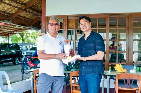 PEF Executive Director Dennis Salvador and Javier Mayor Michael Dragon Javier, share a light moment with a Philippine Eagle plush, symbolizing their shared support for conservation efforts in Leyte.