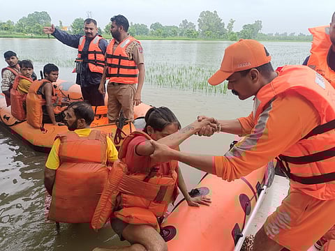 NDRF team rescuing 8 factory workers trapped in Lohara village, Jalandhar, amid heavy rainfall.