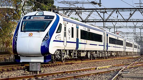 Vande Bharat Express train on tracks, showing modern high-speed design