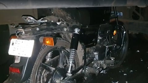 Bike gets trapped under truck