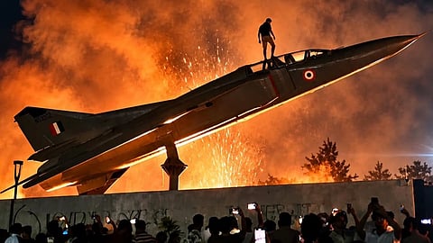 Students climbing onto a decommissioned MiG-23 aircraft