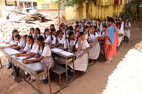 Students listening to a lesson in the ground