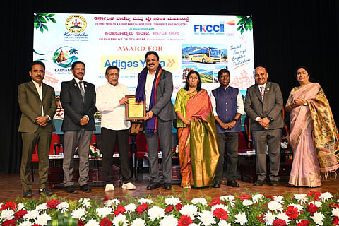 The 'Best Tour Operator' award, presented under the aegis of the State Tourism Department and FKCCI, was awarded to Adigas Yatra. Former Minister M.R. Jayaram, FKCCI President Uma Reddy, and others were present.