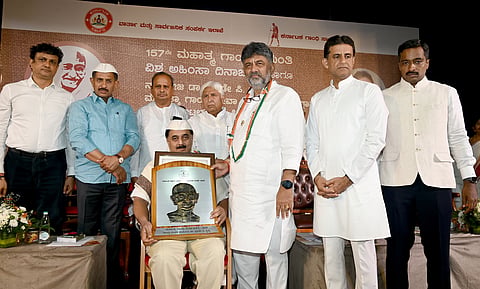 Chief Minister D.K. Shivakumar honored Nadoja Wooday P. Krishna with the Gandhi Seva Award during the Gandhi Jayanti program held at Gandhi Bhavan. Ministers Balakrishna and Rizwan Arshad, former Minister H.K. Patil, and others were present.