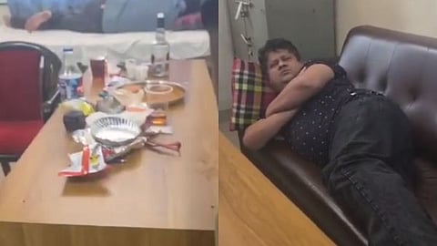 A liquor bottle on a mortuary table, and a suspended government doctor.