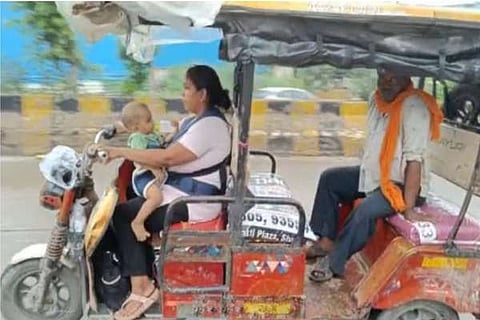 1-yr-old son while driving E-rickshaw