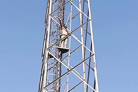 Police Constable on Mobile Phone tower