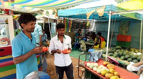In Ranebennur city, people are eating watermelon fruit after being scorched by the sun.