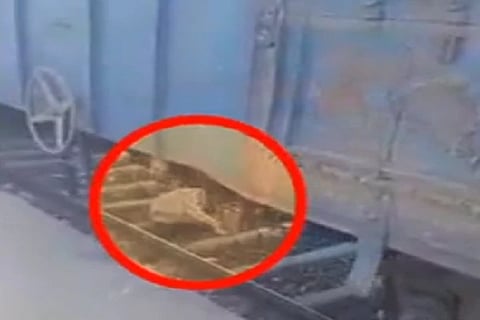 old man stuck under train