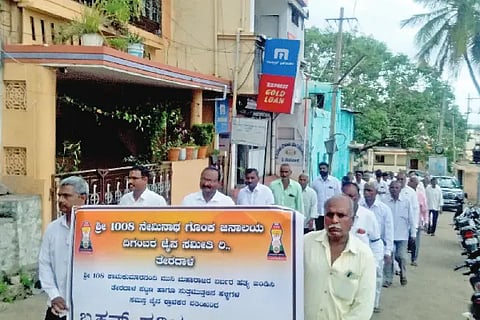 A silent march with black clothes tied around the hands