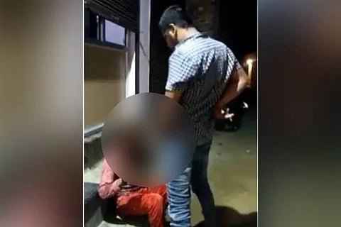 man peeing on labourer
