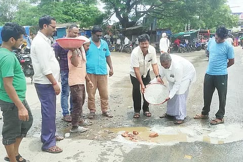 People protesting by repairing road