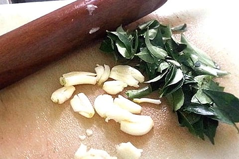 Eating curry leaves and garlic