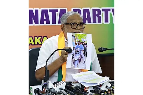 Former minister Suresh Kumar shows photos