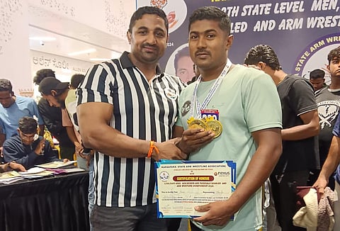 Champion in claw wrestling competition Mandya