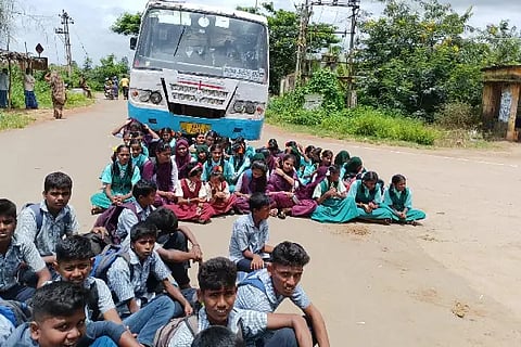 Students protest by blocking the bus