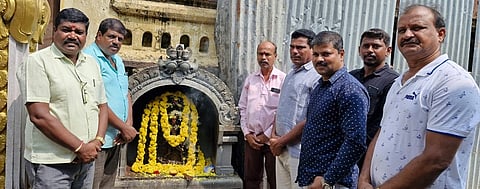 Placing flowers at Maranayaka idol in Mysore