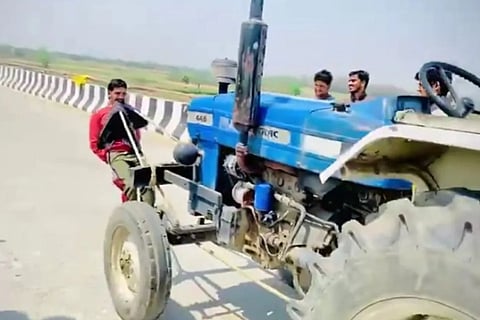 boy pulled tractor with his teeth