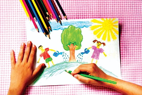 child-paints-picture-pencils-abo.jpg