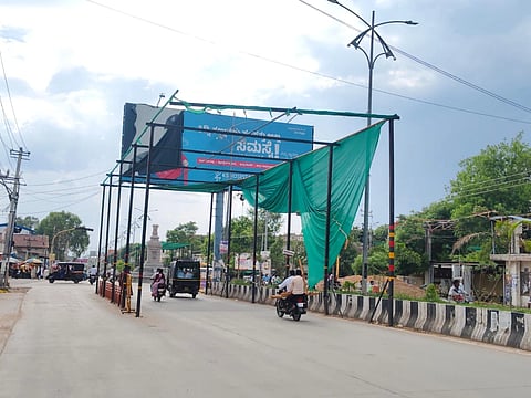 ಕೊಪ್ಪಳದ ಅಶೋಕ ವೃತ್ತದಲ್ಲಿ ಬಳಿ ಬೇಸಿಗೆ ತಾಪದಿಂದ ವಾಹನ ಸವಾರರಿಗೆ ನೆರಳು ಒದಗಿಸುವ ಉದ್ದೇಶದಿಂದ ಅಳವಡಿಸಲಾಗಿದ್ದ ಹಸಿರು ಹೊದಿಕೆ ಕಿತ್ತುಹೋಗಿ ಗಾಳಿಗೆ ತೂರಾಡುತ್ತಿರುವುದು.