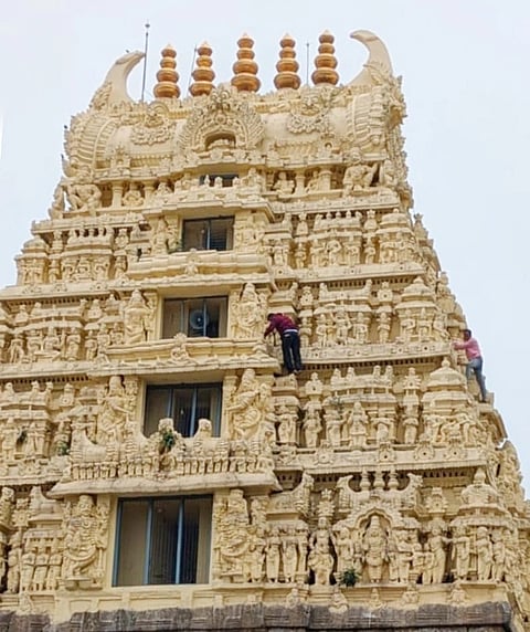ಯಾವುದೇ ಮುಂಜಾಗ್ರತೆ ಹಾಗೂ ಸುರಕ್ಷತಾ ಕ್ರಮ ಕೈಗೊಳ್ಳದೆ ಶ್ರೀ ಚನ್ನಕೇಶವಸ್ವಾಮಿ ದೇವಸ್ಥಾನದ ರಾಜ ಗೋಪುರದ ಸ್ವಚ್ಛತೆಯಲ್ಲಿ ತೊಡಗಿರುವ ಕಾರ್ಮಿಕರು.